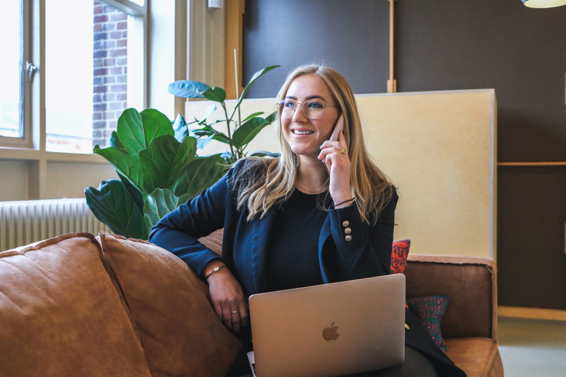 woman using phone and laptop