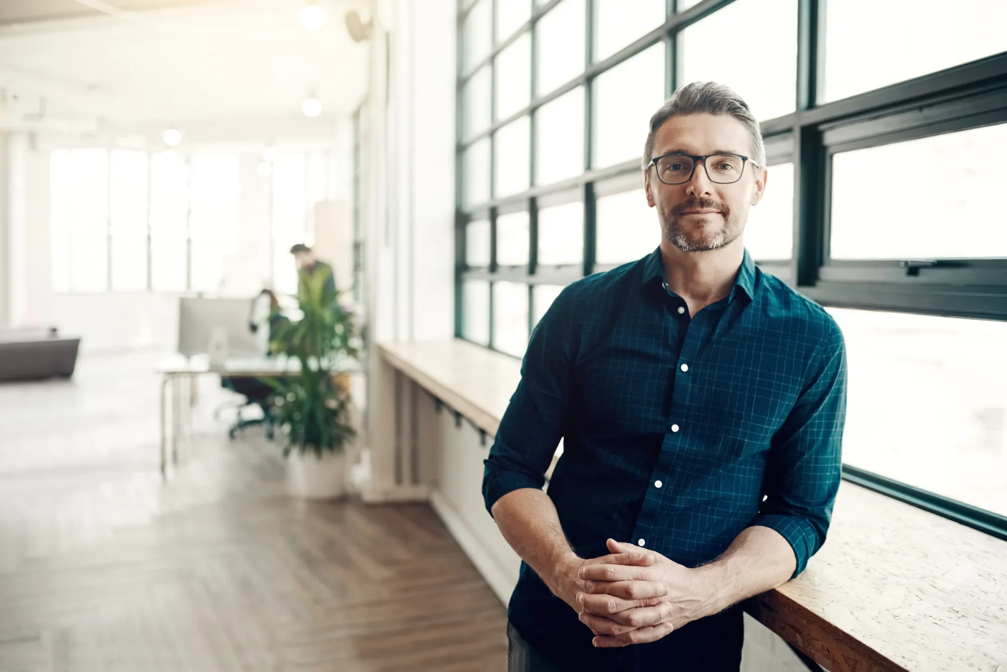 Portrait of a businessman standing in a modern office.